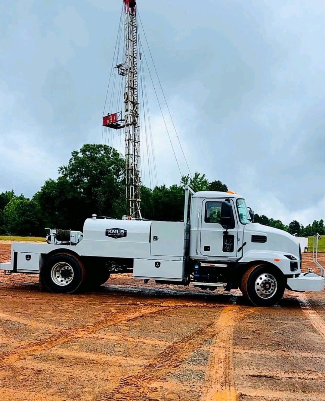 KMLB swab unit with mast and winch at a wellsite
